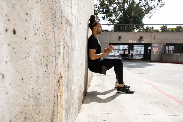 Young afroamerican man getting fit in Los Angeles downtown city streets, USA.
